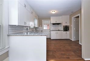 2527 Oakcliff Street Houston, TX 77023 - Photo 4 of 15 a kitchen with stainless steel appliances granite countertop a sink stove and cabinets