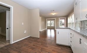 2527 Oakcliff Street Houston, TX 77023 - Photo 6 of 15 wooden floor in an empty room with a window