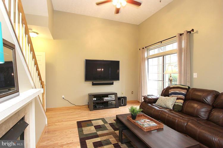 11864 Breton Court, Unit 14A Reston, VA 20191 - Photo 7 of 23 Living Room Sliding Door Opens to Patio