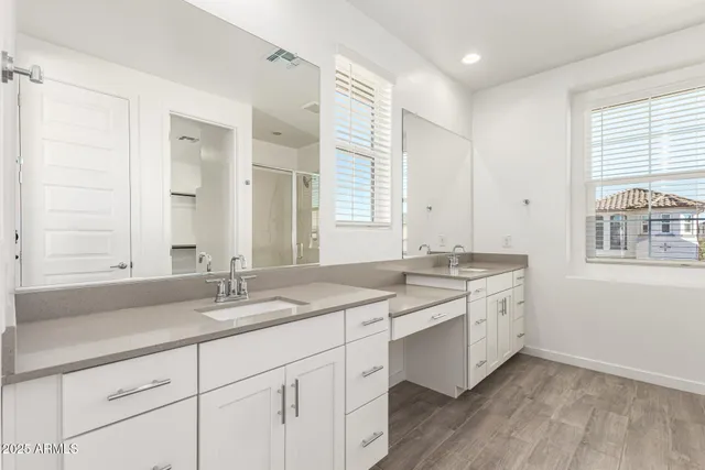 a bathroom with a sink double vanity and a tub