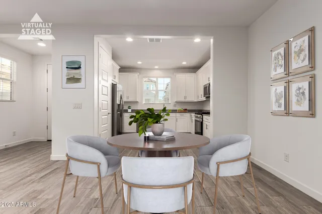 a dining room with furniture and wooden floor