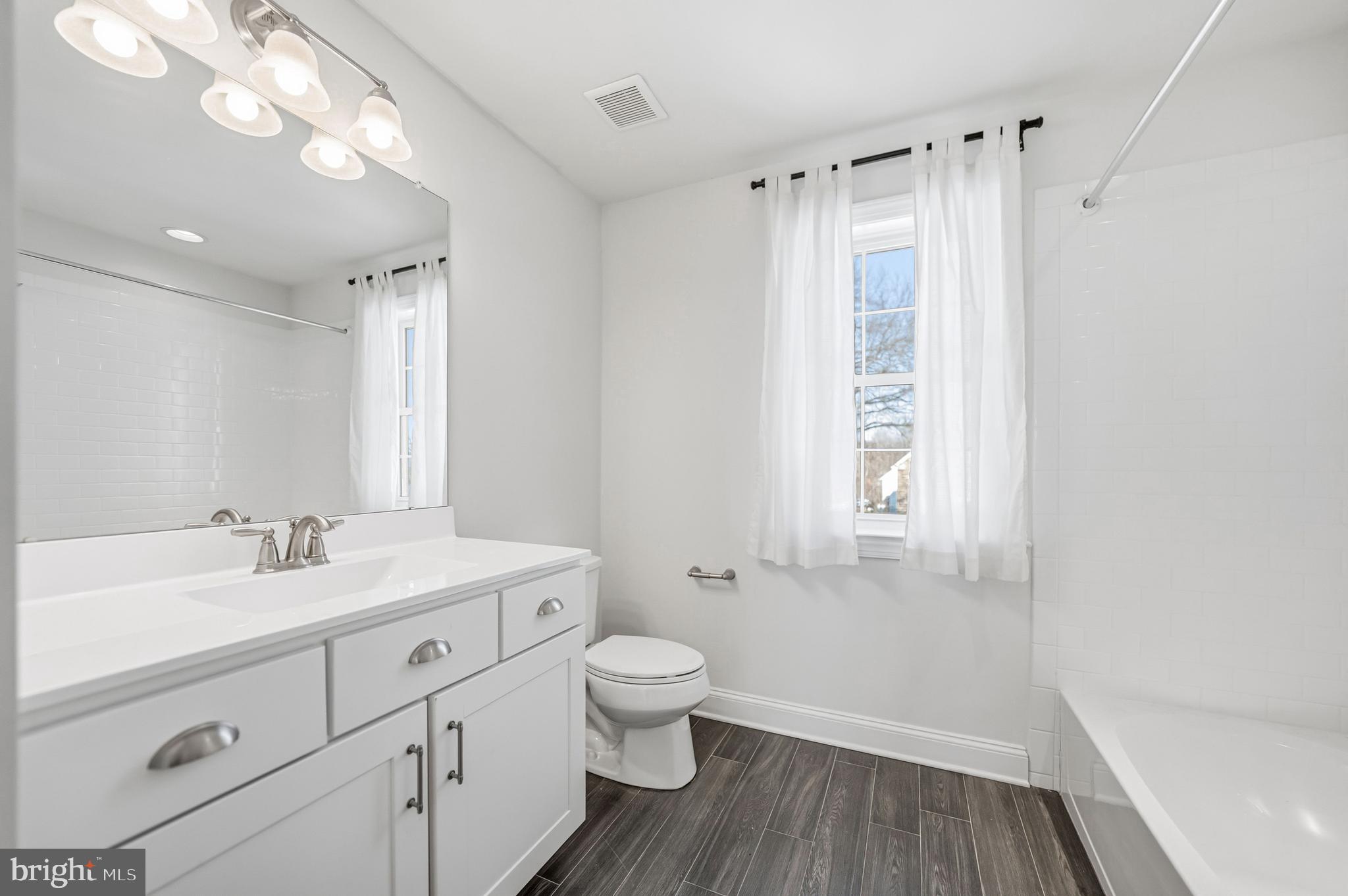 4777 Old Easton Road Doylestown, PA 18902 - Photo 21 of 26 a bathroom with a sink a toilet and a large mirror