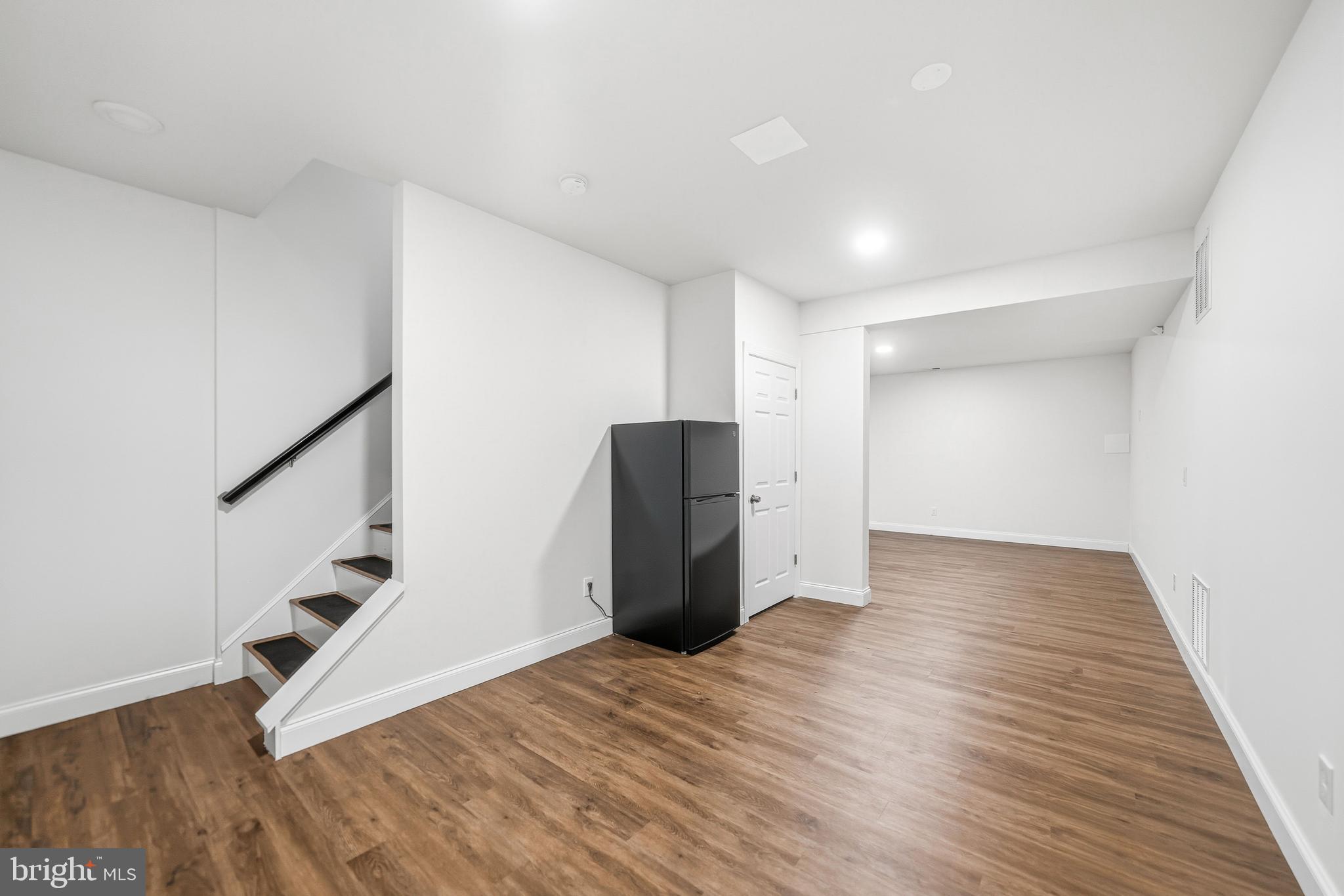 4777 Old Easton Road Doylestown, PA 18902 - Photo 24 of 26 a view of an empty room with wooden floor and stairs