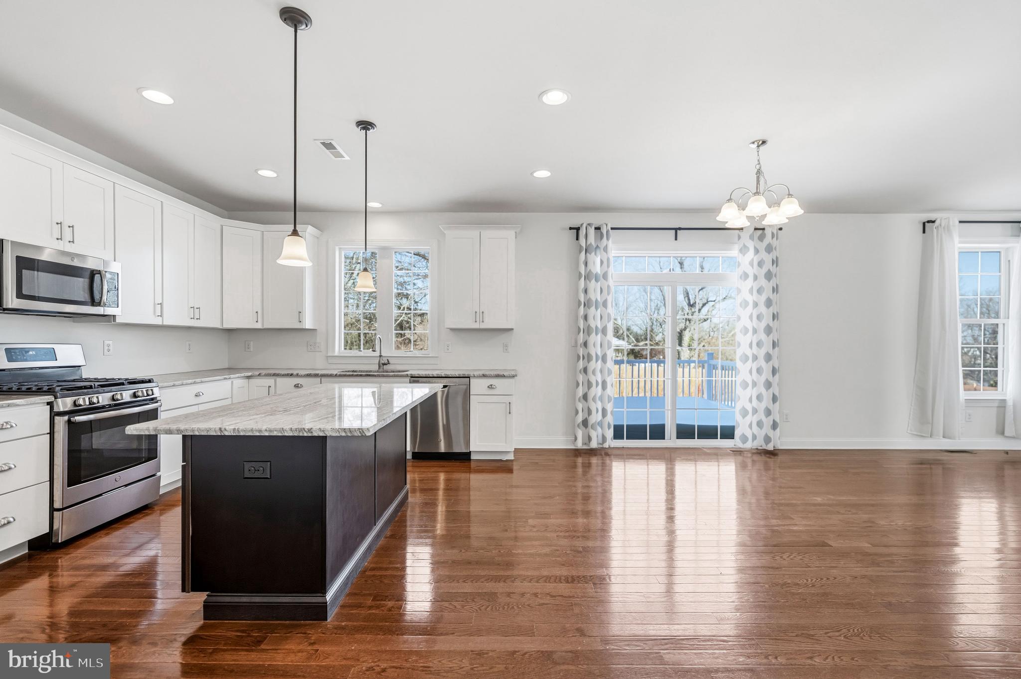 4777 Old Easton Road Doylestown, PA 18902 - Photo 6 of 26 a kitchen with stainless steel appliances granite countertop wooden floors and white cabinets