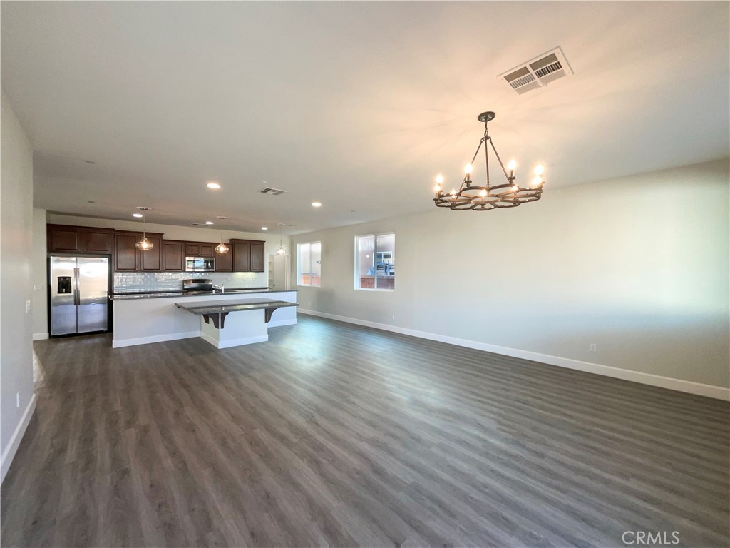 26625 Emperor Road Menifee, CA 92585 - Photo 15 of 24 a view of kitchen and dining room with wooden floor