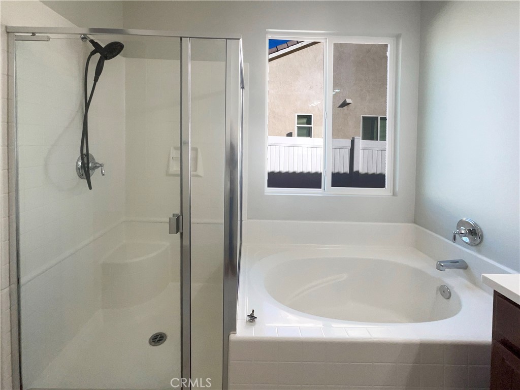 26625 Emperor Road Menifee, CA 92585 - Photo 19 of 24 a white bath tub sitting next to a shower