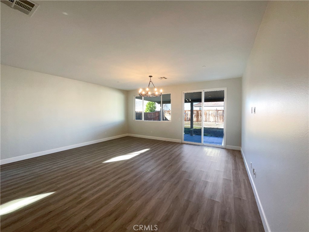 26625 Emperor Road Menifee, CA 92585 - Photo 3 of 24 wooden floor in an empty room with a window