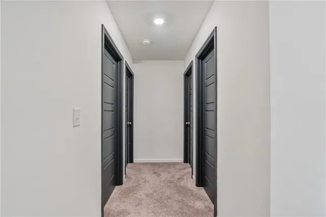 a spacious bedroom with a bed and large window