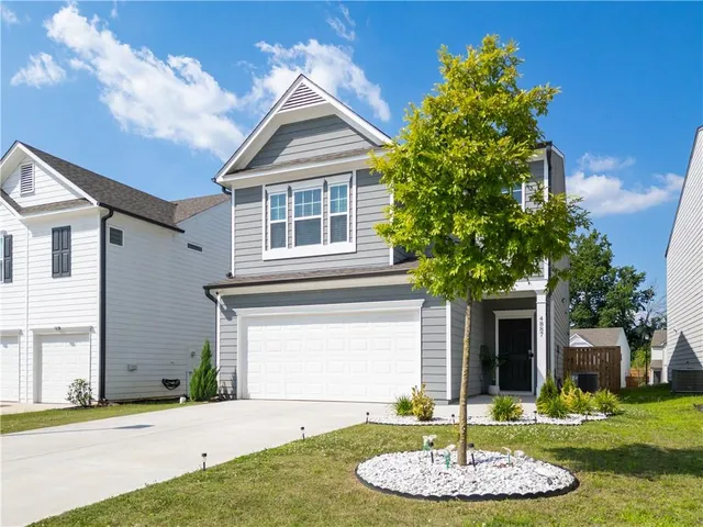 a front view of a house with a yard and garage
