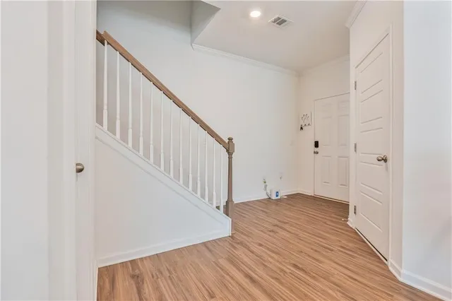 a view of a hallway view with wooden floor and staircase