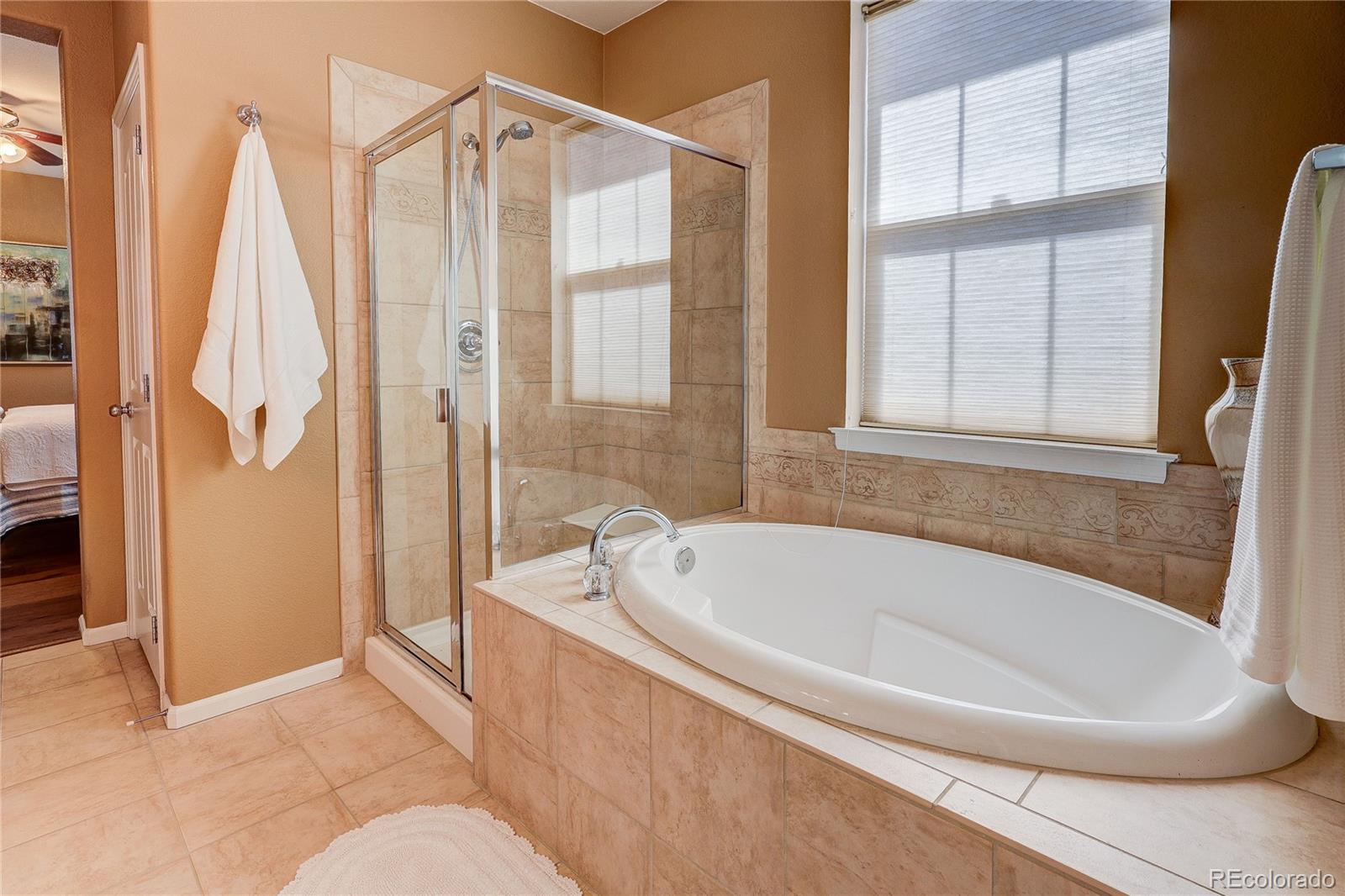 10556 Graymont Lane, Unit B Highlands Ranch, CO 80126 - Photo 20 of 40 a white bath tub sitting next to a bathroom