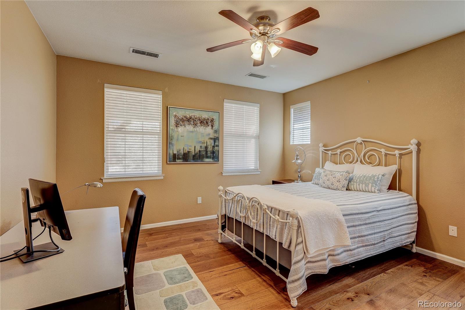10556 Graymont Lane, Unit B Highlands Ranch, CO 80126 - Photo 24 of 40 a bedroom with a bed and a chandelier