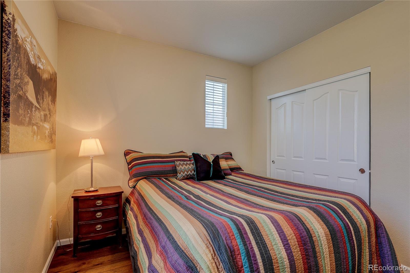 10556 Graymont Lane, Unit B Highlands Ranch, CO 80126 - Photo 26 of 40 a bedroom with double bed and a closet