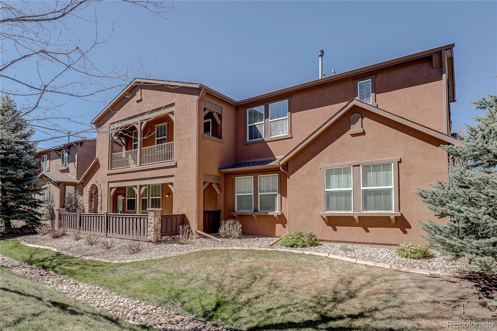 10556 Graymont Lane, Unit B Highlands Ranch, CO 80126 - Photo 34 of 40 a front view of a house with a yard