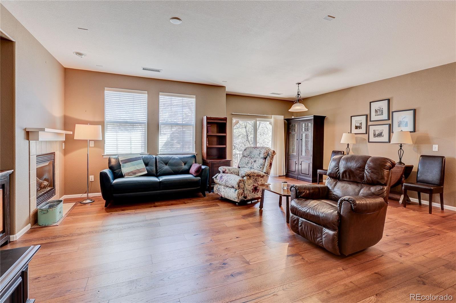 10556 Graymont Lane, Unit B Highlands Ranch, CO 80126 - Photo 5 of 40 a living room with furniture and a fireplace