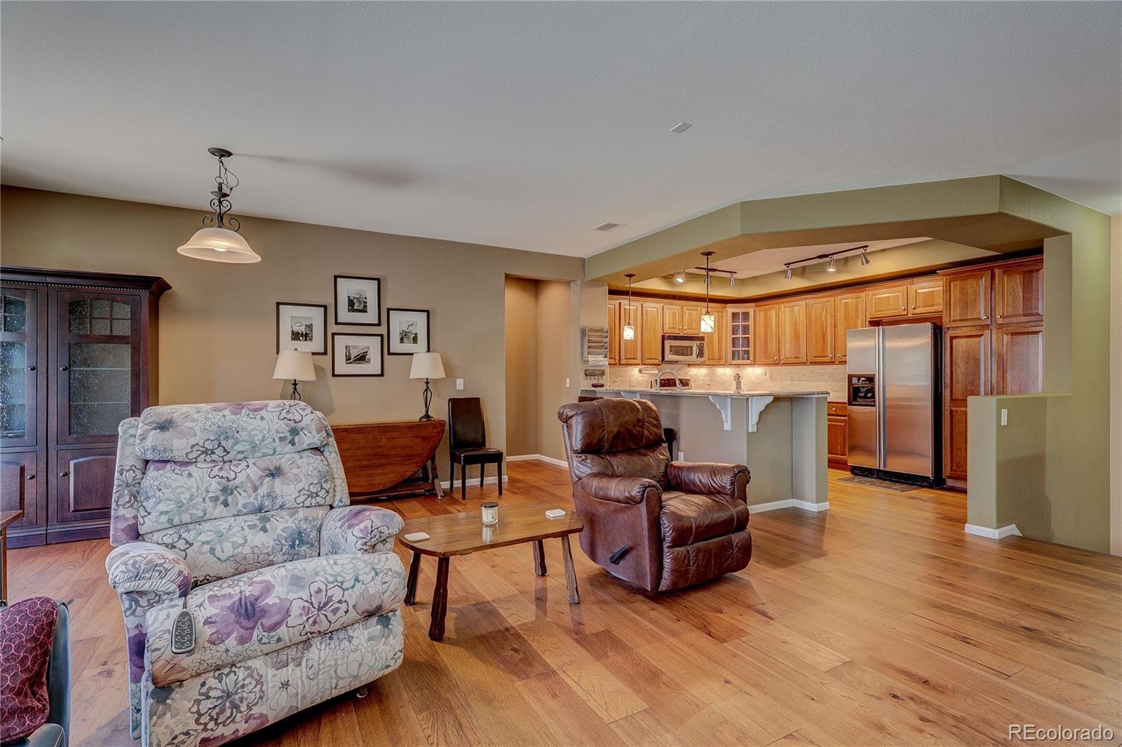 10556 Graymont Lane, Unit B Highlands Ranch, CO 80126 - Photo 7 of 40 a living room with furniture and a wooden floor