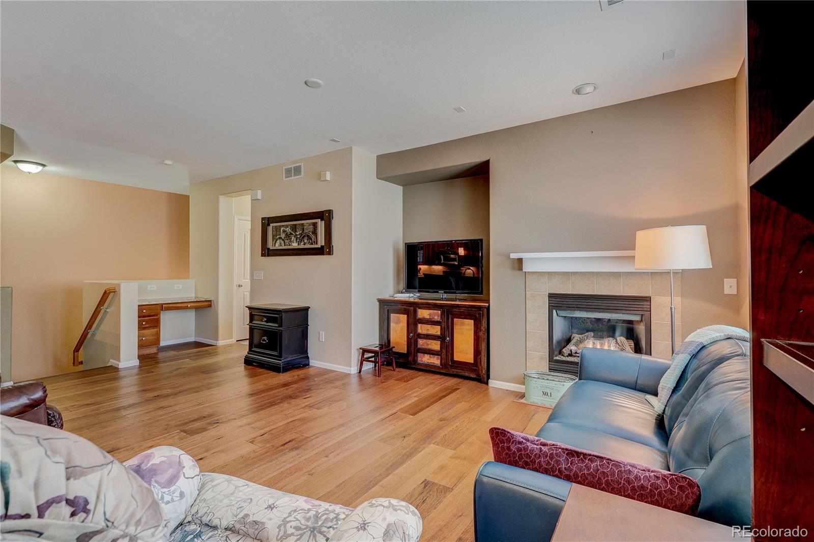 10556 Graymont Lane, Unit B Highlands Ranch, CO 80126 - Photo 8 of 40 a living room with furniture and a fireplace