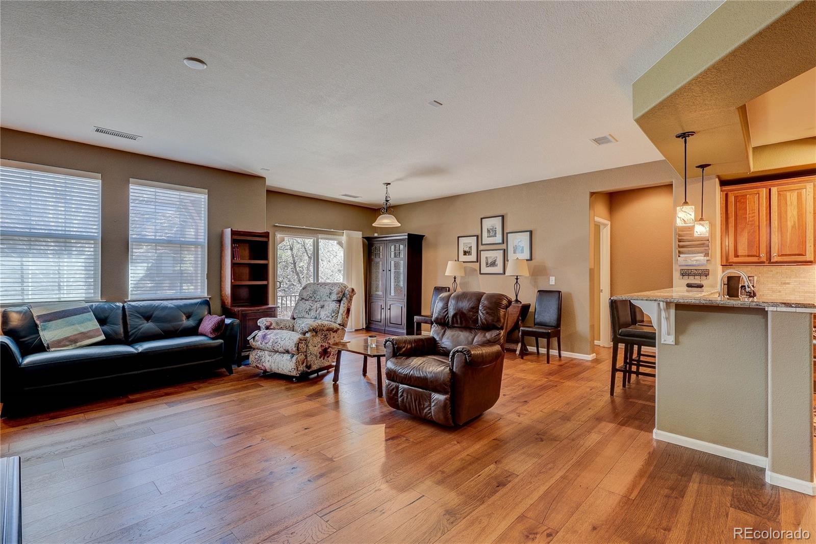 10556 Graymont Lane, Unit B Highlands Ranch, CO 80126 - Photo 9 of 40 a living room with furniture and a wooden floor