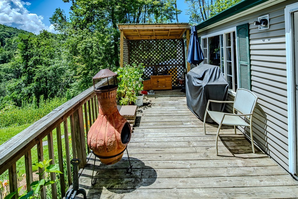 461 Reuben Wooten Road Banner Elk, NC 28604 - Photo 8 of 39 a balcony with chairs and wooden floor