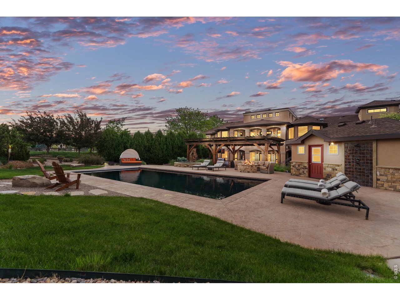 964 Riparian Way Fort Collins, CO 80524 - Photo 20 of 42 a view of a patio with couches and table and chairs and a yard