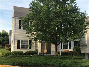 front view of a house with a tree