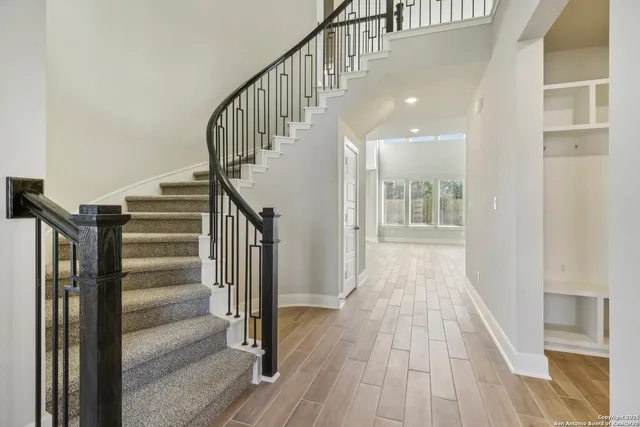 a view of entryway with wooden floor and stairs