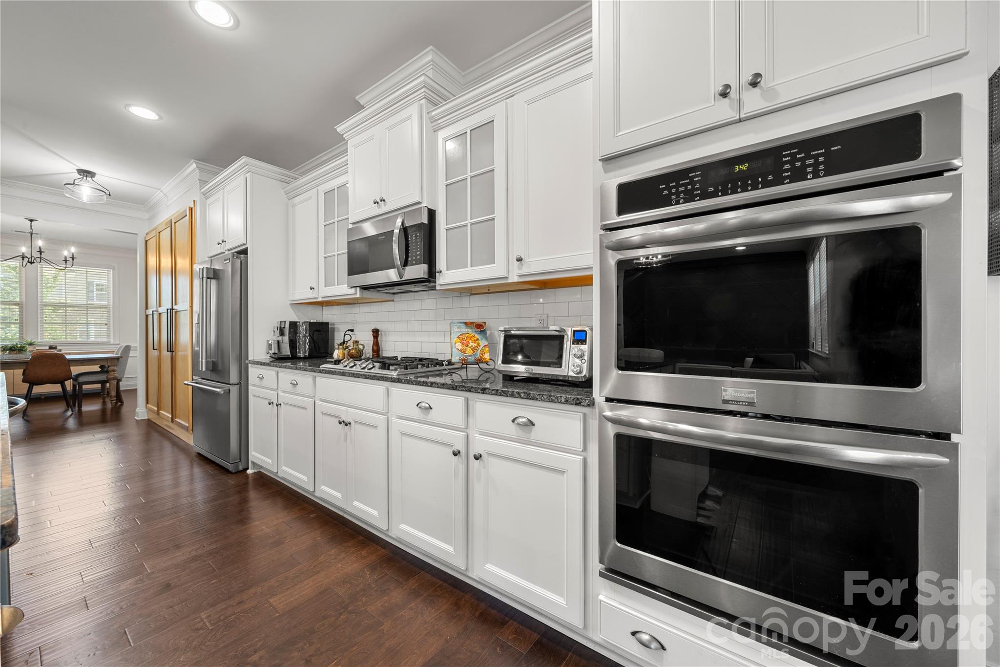 11266 Trailside Road Concord, NC 28027 - Photo 18 of 48 a kitchen with stainless steel appliances white cabinets and a stove top oven