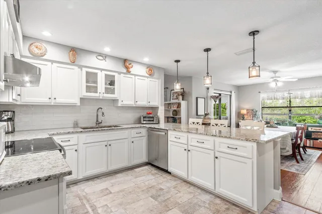 a kitchen with a sink stove and cabinets