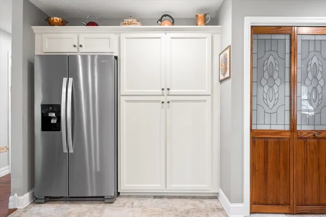 a view of a kitchen with refrigerator and cabinet