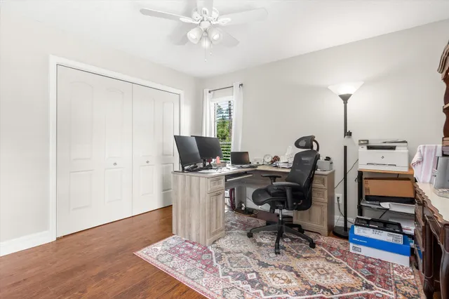 a view of a workspace with furniture and a window