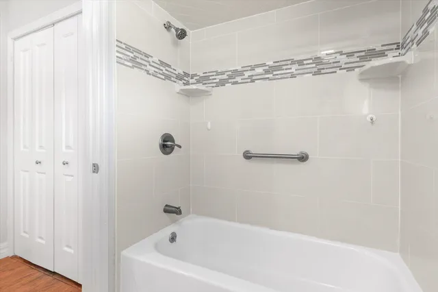 a bathroom with a shower and a bath tub