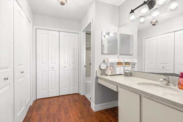 a bathroom with a sink double vanity granite tub and shower