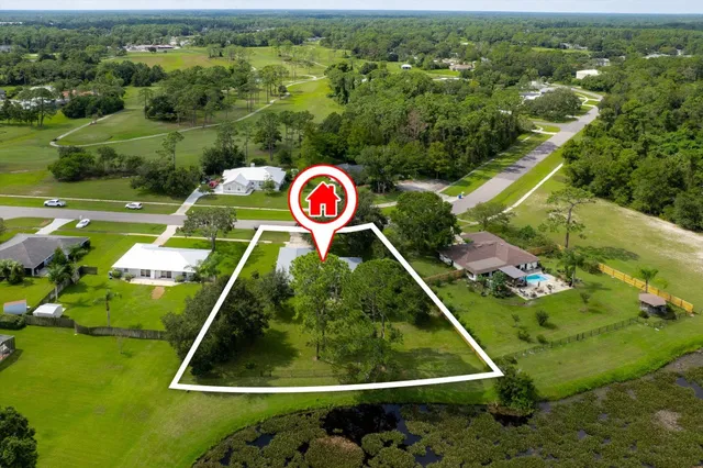 an aerial view of a golf course with parking space