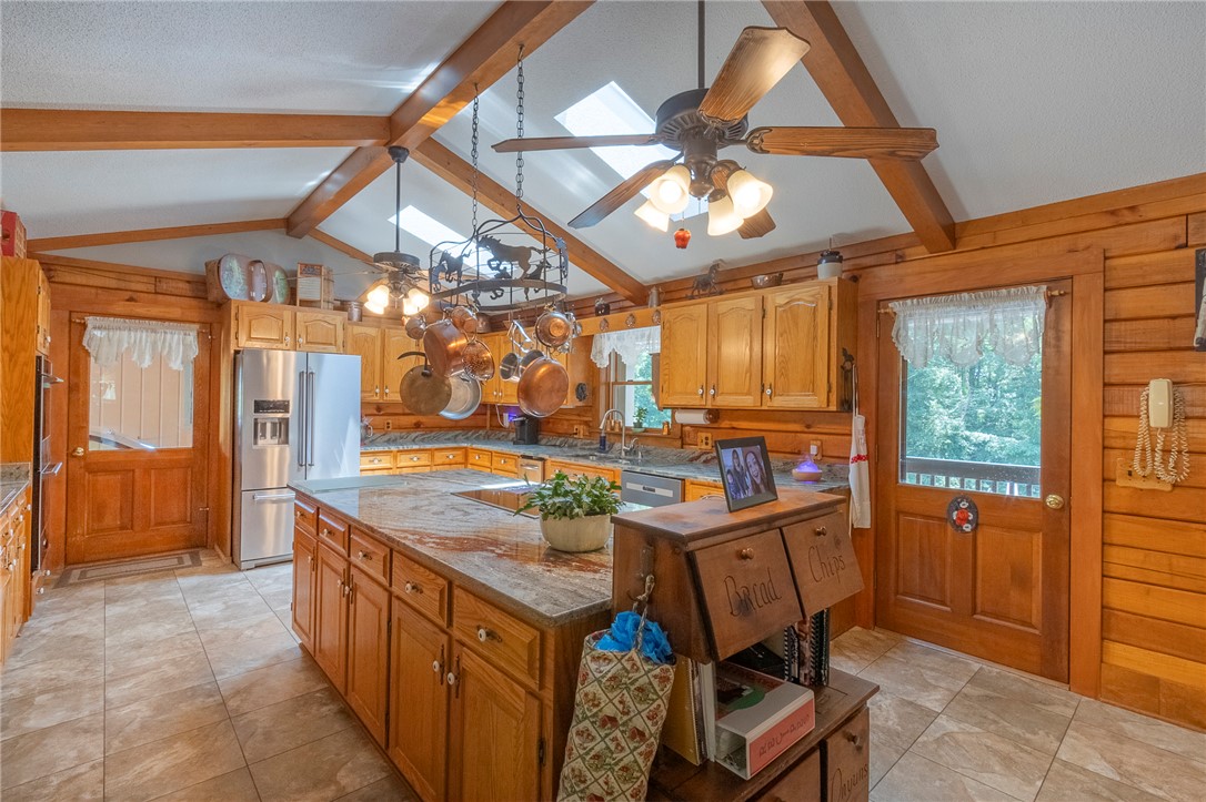 911 State Rd S-4-203 Belton, SC 29627 - Photo 9 of 49 A well-equipped kitchen features a large center island, abundant cabinet storage, and skylights illuminating the functional space.