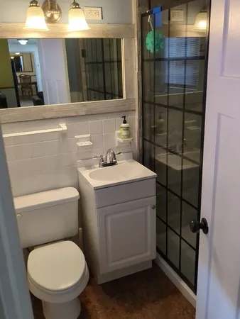 a bathroom with a toilet sink and shower