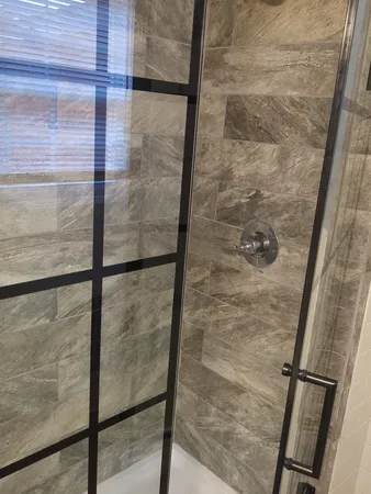 a bathroom with a glass shower door