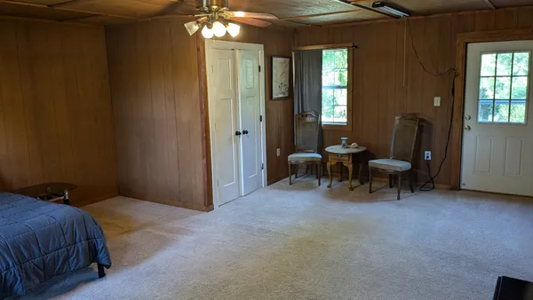 a bedroom with a bed and a chandelier