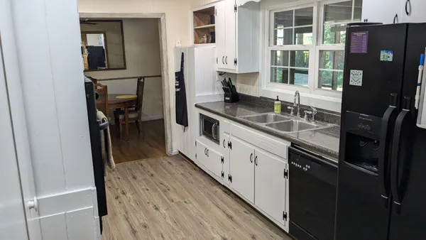 a kitchen with stainless steel appliances granite countertop a refrigerator and a sink