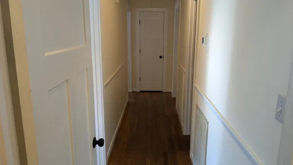 a view of a hallway with the door