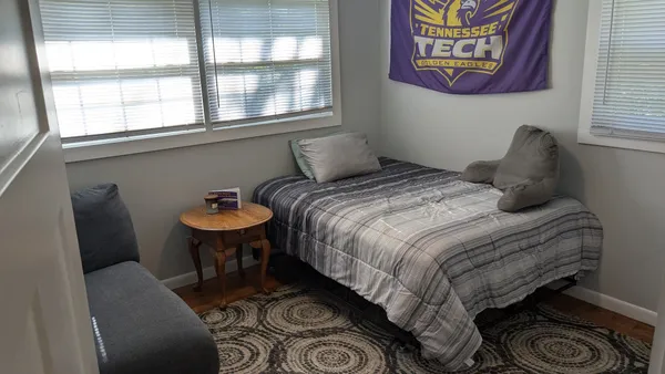 a bedroom with a bed and a window