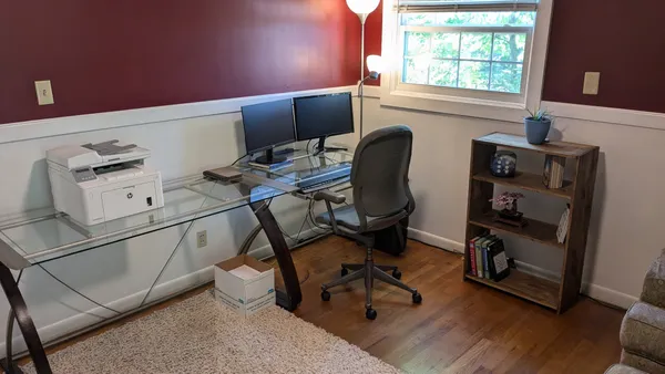 a view of workspace with wooden floor windows