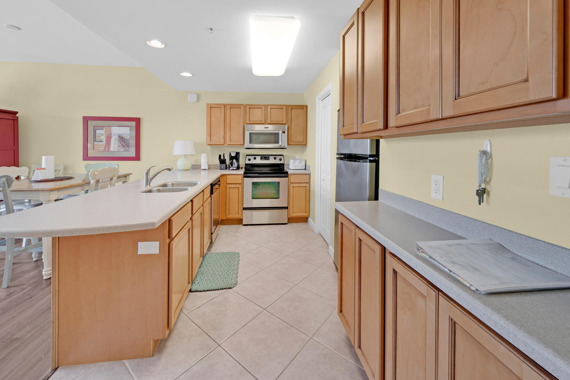 548 Sandy Cay Drive, Unit 309 Miramar Beach, FL 32550 - Photo 17 of 47 a kitchen with stainless steel appliances granite countertop a sink stove and refrigerator