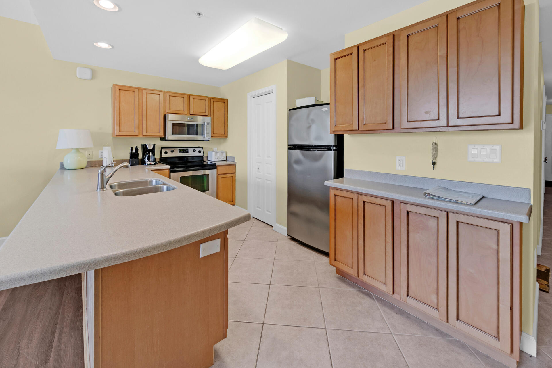 548 Sandy Cay Drive, Unit 309 Miramar Beach, FL 32550 - Photo 18 of 47 a kitchen with stainless steel appliances granite countertop a refrigerator sink stove microwave and cabinets