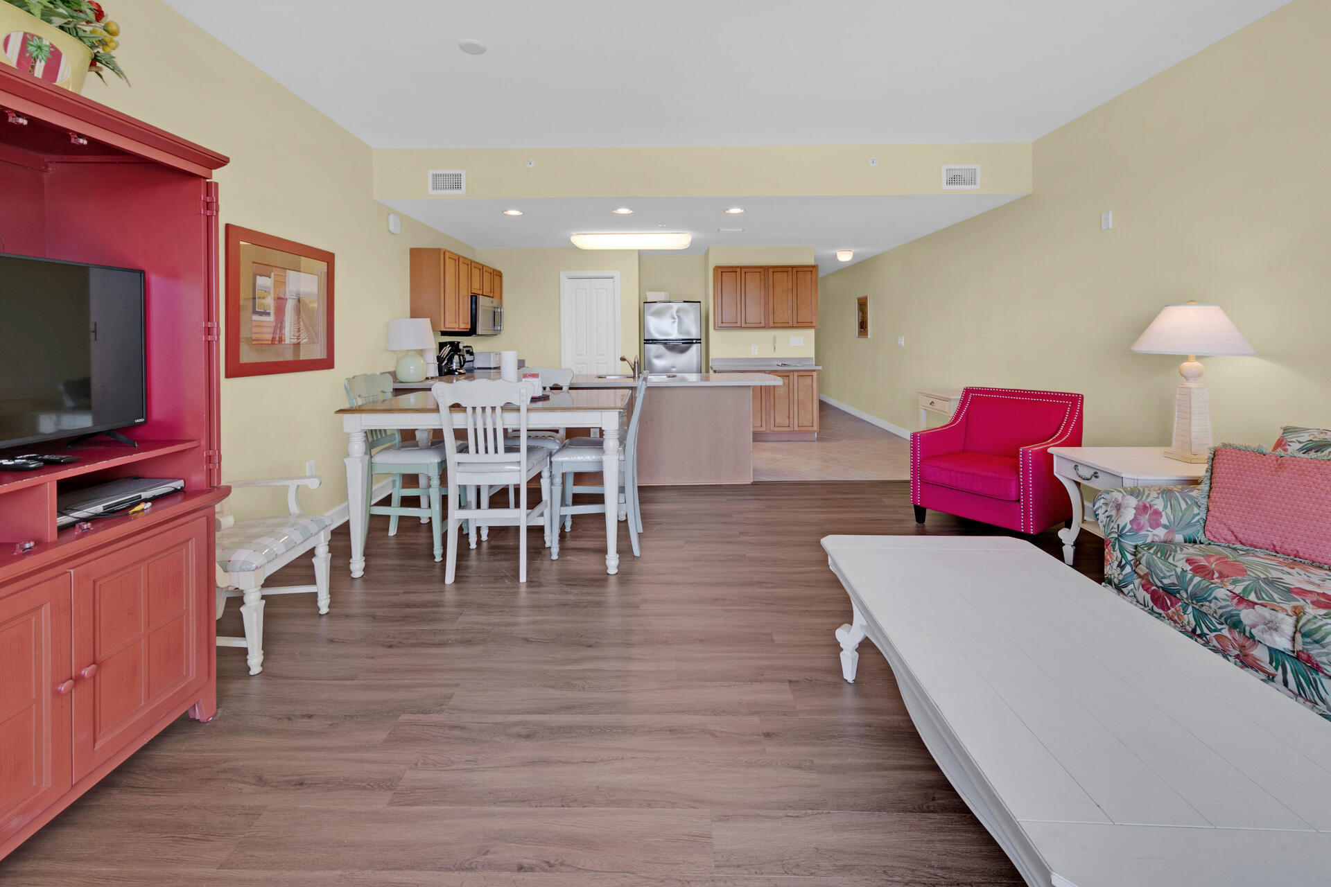 548 Sandy Cay Drive, Unit 309 Miramar Beach, FL 32550 - Photo 25 of 47 a living room with furniture a flat screen tv and kitchen view