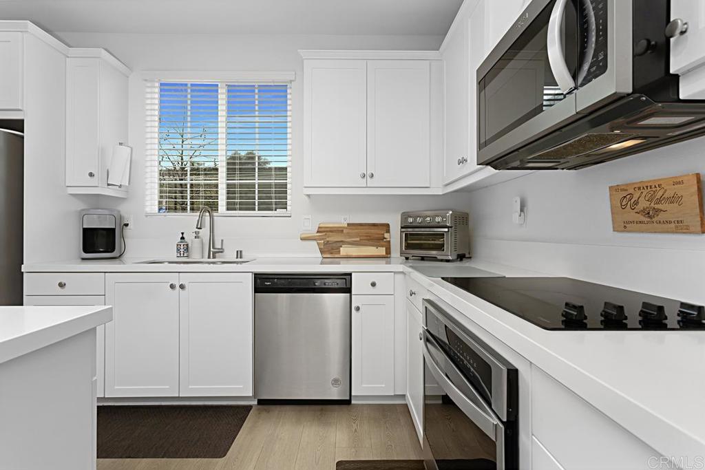 5410 Luna Way Bonsall, CA 92003 - Photo 13 of 37 a kitchen with granite countertop a sink a stove and cabinets