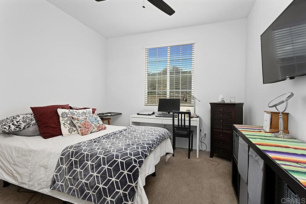 5410 Luna Way Bonsall, CA 92003 - Photo 16 of 37 a bedroom with a bed and a flat screen tv
