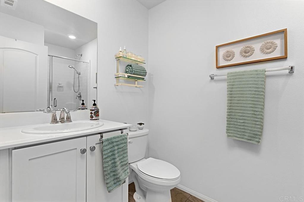 5410 Luna Way Bonsall, CA 92003 - Photo 17 of 37 a bathroom with a toilet sink and mirror