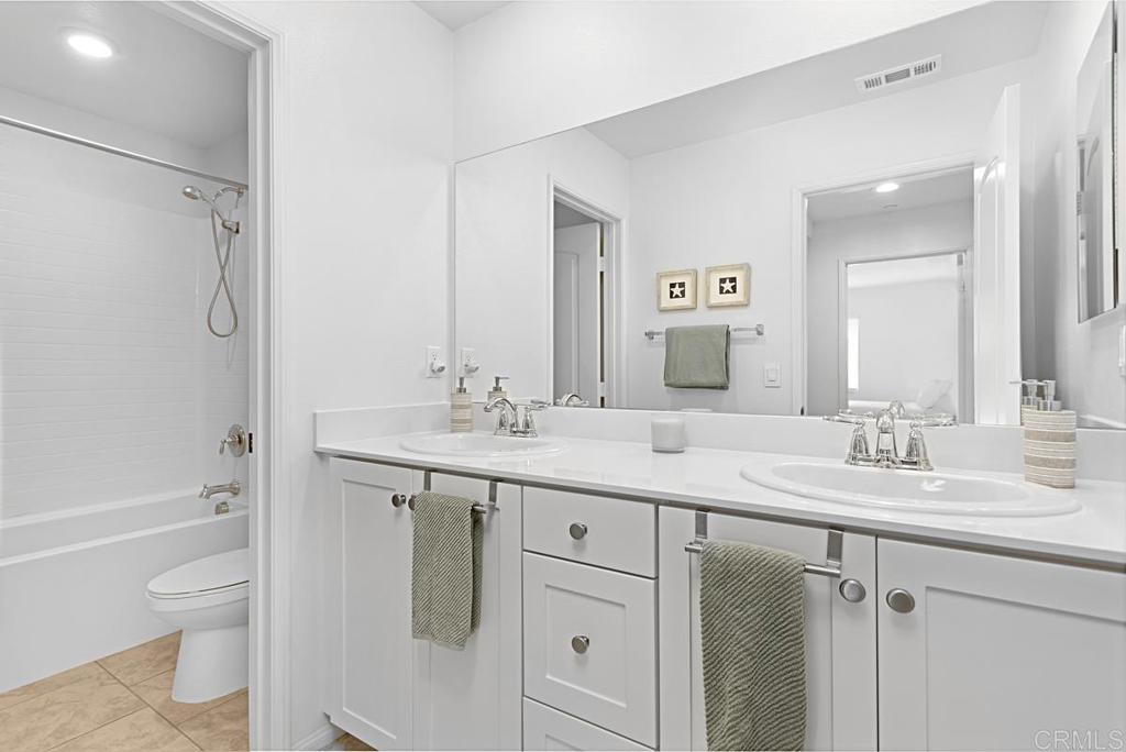 5410 Luna Way Bonsall, CA 92003 - Photo 24 of 37 a bathroom with a granite countertop sink a toilet and a bathtub