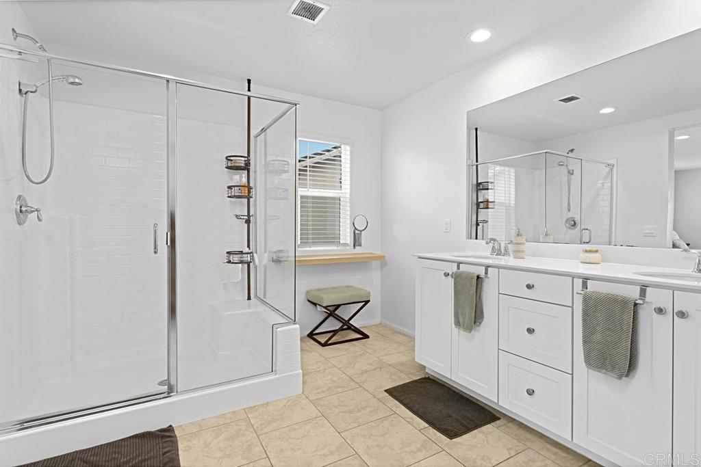 5410 Luna Way Bonsall, CA 92003 - Photo 30 of 37 a spacious bathroom with a double vanity sink a mirror and a bathtub