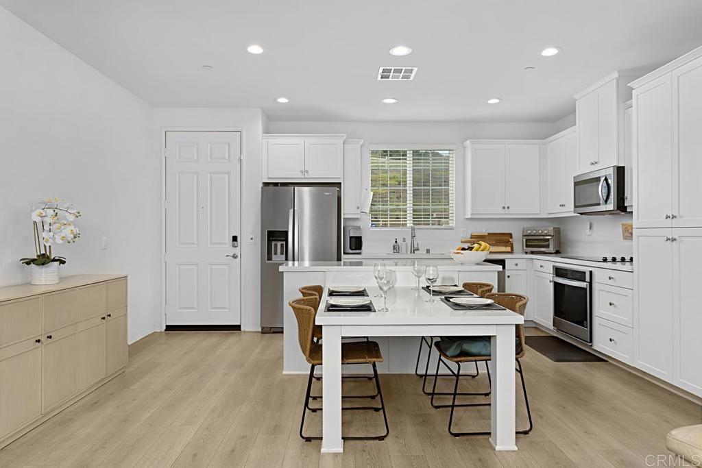 5410 Luna Way Bonsall, CA 92003 - Photo 10 of 37 a kitchen with refrigerator a stove and chairs